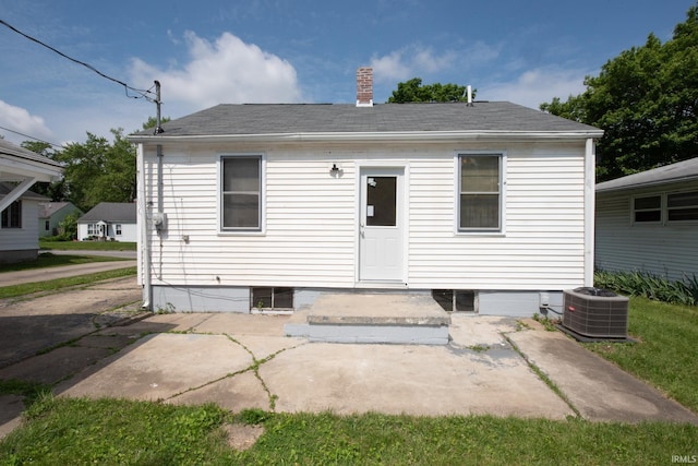 2331 N 24th St, Lafayette, IN 47904 - back of property featuring central air condition unit, a patio area, a chimney, and roof with shingles