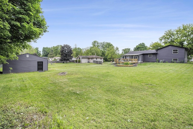 61156 Old Spanish Trl, South Bend, IN 46614 - view of green lawn featuring a wooden deck and an outbuilding