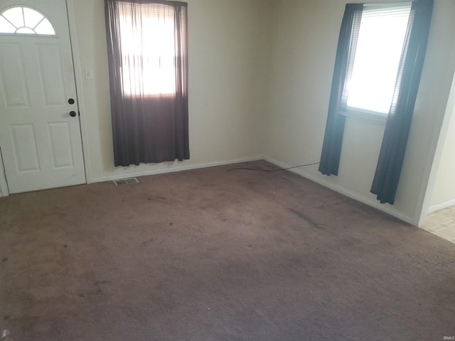 406 W Rogers St, Osceola, IN 46561 - entrance foyer featuring healthy amount of natural light, carpet, and baseboards
