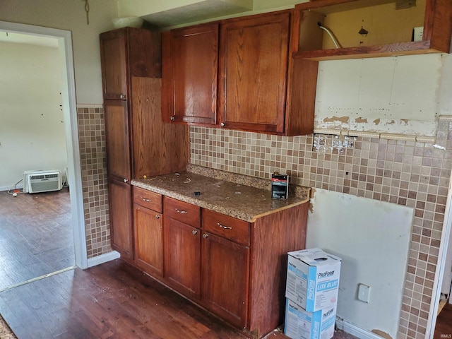 406 W Rogers St, Osceola, IN 46561 - kitchen with dark wood-type flooring, tile walls, brown cabinetry, stone countertops, and backsplash