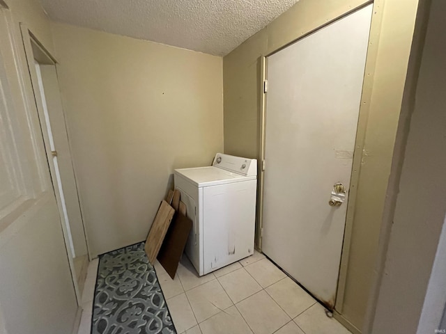 607 N 10th St, Vincennes, IN 47591 - laundry area with washer / dryer, a textured ceiling, and light tile patterned floors