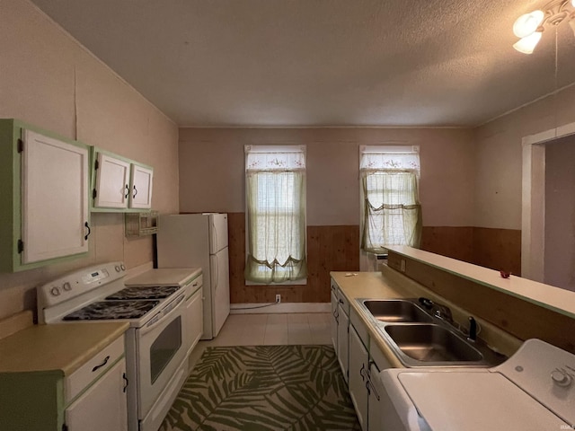 607 N 10th St, Vincennes, IN 47591 - kitchen with white appliances, a sink, light countertops, white cabinetry, and a textured ceiling