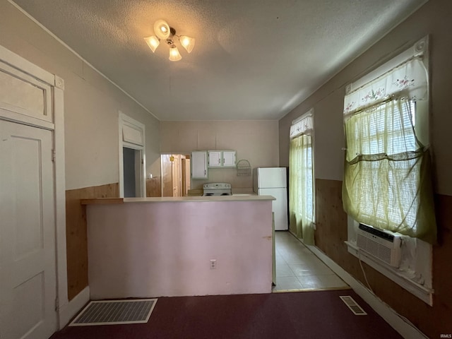 607 N 10th St, Vincennes, IN 47591 - kitchen featuring white appliances, a peninsula, white cabinets, and cooling unit