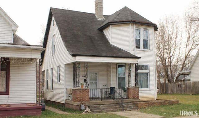 509 E Michigan St, Evansville, IN 47711 - view of front of house with a porch, a chimney, and roof with shingles