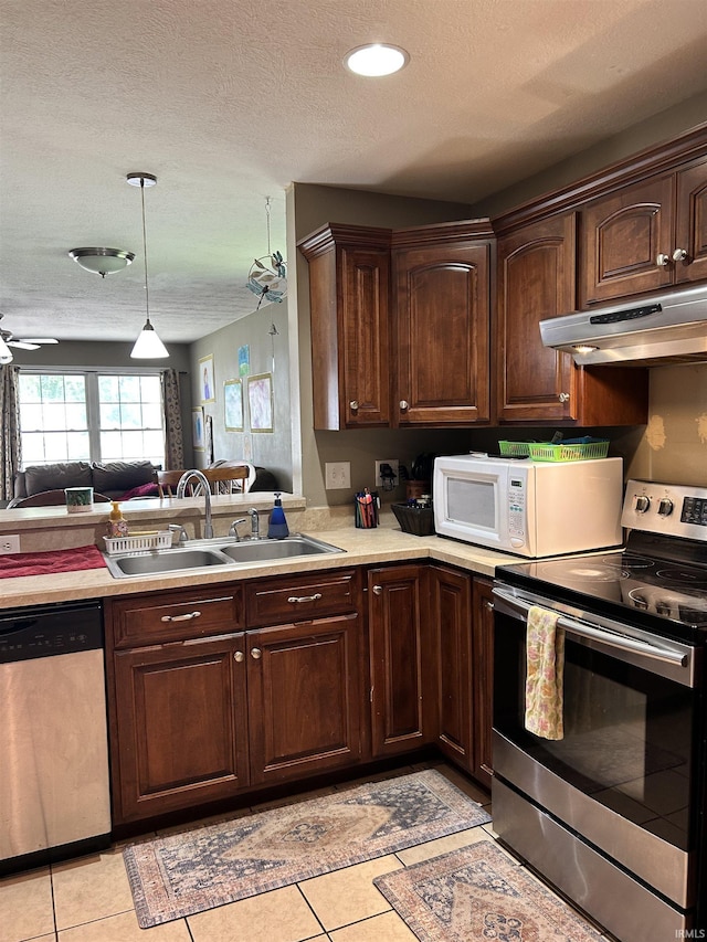 1406 Hillcrest Rd, Bedford, IN 47421 - kitchen featuring appliances with stainless steel finishes, under cabinet range hood, a sink, light countertops, and a textured ceiling