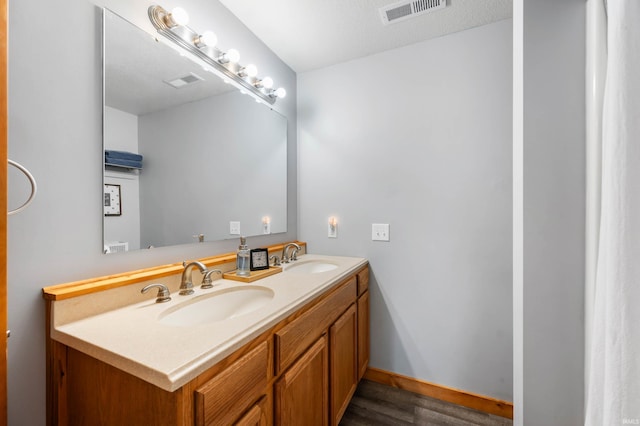 303 Shrack Ln, Dunkirk, IN 47336 - full bath featuring double vanity, wood finished floors, and baseboards