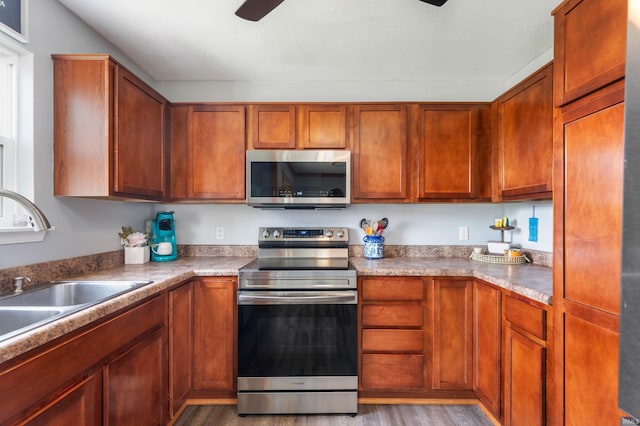 303 Shrack Ln, Dunkirk, IN 47336 - kitchen featuring appliances with stainless steel finishes, light wood-type flooring, a sink, and ceiling fan