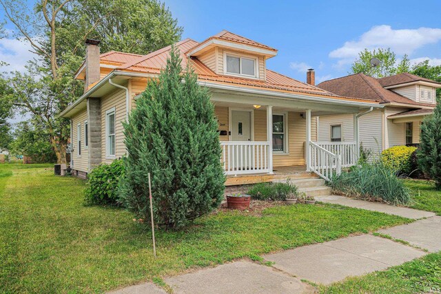 407 N Front St, North Manchester, IN 46962 - view of front of property with a chimney, covered porch, and a front lawn