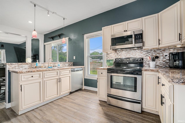 407 N Front St, North Manchester, IN 46962 - kitchen with appliances with stainless steel finishes, a sink, light wood-type flooring, backsplash, and track lighting