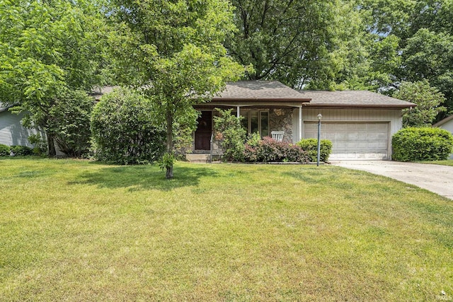 17411 Woodhurst Rd, Granger, IN 46530 - view of front of house featuring an attached garage, concrete driveway, a front lawn, and stone siding