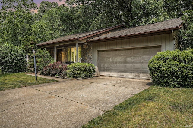 17411 Woodhurst Rd, Granger, IN 46530 - view of front facade with an attached garage, concrete driveway, stone siding, a front yard, and a shingled roof