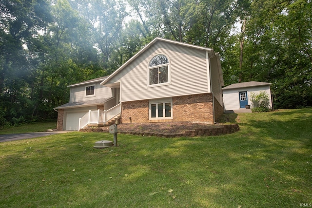 1153 N Diamond Point Ct, Monticello, IN 47960 - view of front of home featuring brick siding, an attached garage, a front lawn, and asphalt driveway