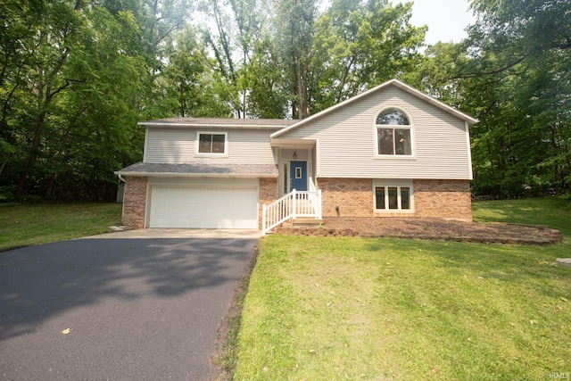 1153 N Diamond Point Ct, Monticello, IN 47960 - raised ranch with brick siding, asphalt driveway, a front lawn, and an attached garage