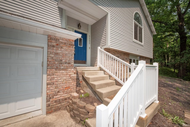 1153 N Diamond Point Ct, Monticello, IN 47960 - doorway to property with brick siding and a garage