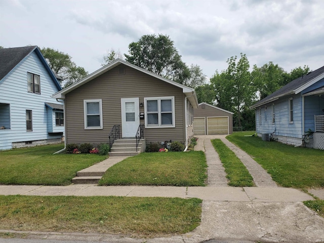 1005 E 4th St, Mishawaka, IN 46544 - bungalow-style home with a garage, an outbuilding, a front yard, and central air condition unit