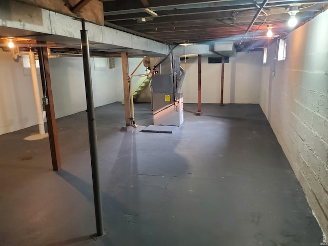1005 E 4th St, Mishawaka, IN 46544 - basement with heating unit, stairs, and concrete block wall