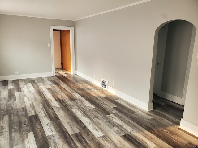 1005 E 4th St, Mishawaka, IN 46544 - spare room featuring arched walkways, wood finished floors, ornamental molding, and baseboards