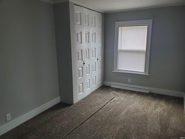1005 E 4th St, Mishawaka, IN 46544 - unfurnished bedroom with a baseboard radiator, baseboards, carpet flooring, a closet, and crown molding