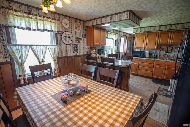 12350 Cedar Rd, Bourbon, IN 46504 - dining room with wallpapered walls, plenty of natural light, light wood-type flooring, wainscoting, and a chandelier