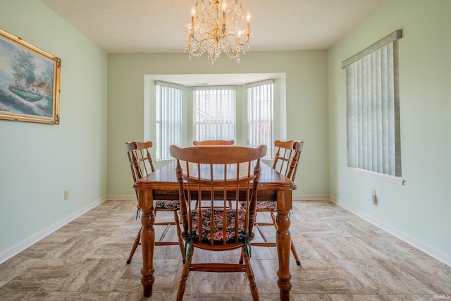 1843 Valley View Dr, Kokomo, IN 46902 - dining space featuring a chandelier, baseboards, and stone finish floors