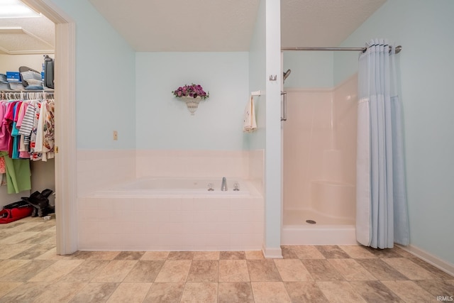 1843 Valley View Dr, Kokomo, IN 46902 - bathroom with a garden tub, a stall shower, a walk in closet, and a textured ceiling