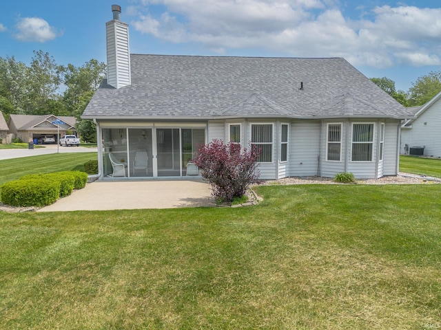 1843 Valley View Dr, Kokomo, IN 46902 - rear view of house with a chimney, a yard, a shingled roof, central AC, and a patio area