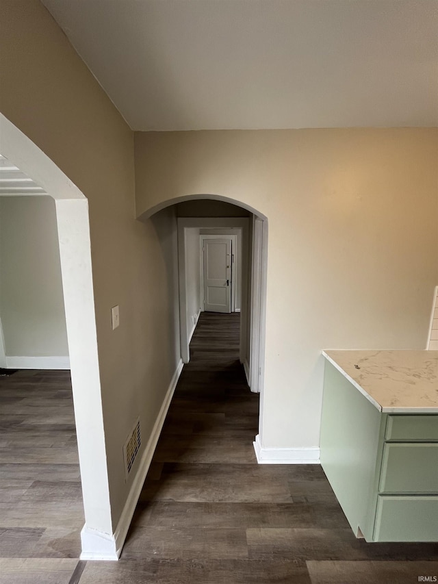 211 S Liberty St, Muncie, IN 47305 - hall featuring arched walkways, dark wood-style flooring, and baseboards