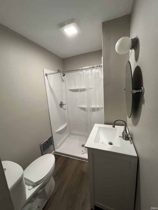 211 S Liberty St, Muncie, IN 47305 - full bath featuring wood finished floors, toilet, a shower stall, and vanity