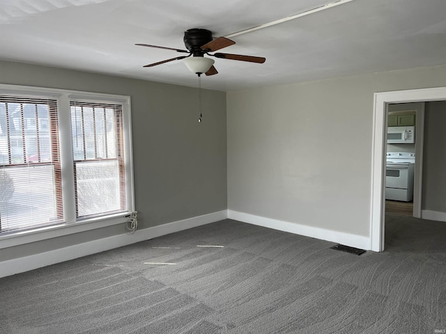 211 S Liberty St, Muncie, IN 47305 - unfurnished room with dark carpet, a ceiling fan, and baseboards