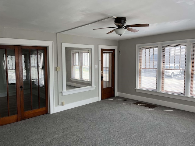 211 S Liberty St, Muncie, IN 47305 - entrance foyer with carpet floors, ceiling fan, and baseboards