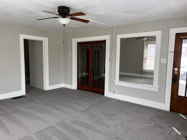 211 S Liberty St, Muncie, IN 47305 - spare room with a ceiling fan, carpet floors, and baseboards