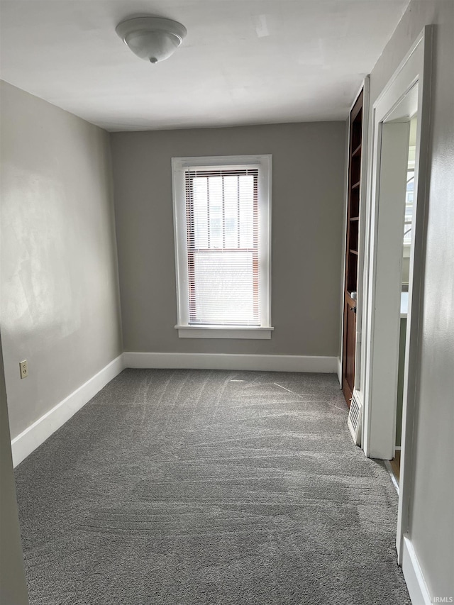 211 S Liberty St, Muncie, IN 47305 - carpeted spare room with baseboards