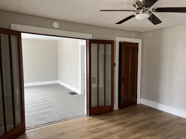211 S Liberty St, Muncie, IN 47305 - unfurnished bedroom with baseboards, wood finished floors, and ceiling fan