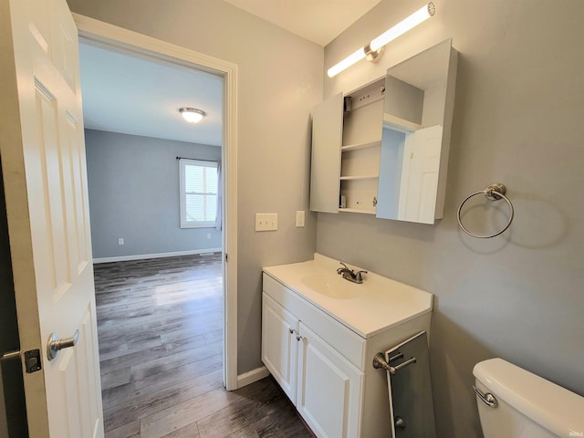 1702 Milburn Blvd, Mishawaka, IN 46544 - half bathroom featuring wood finished floors, vanity, toilet, and baseboards