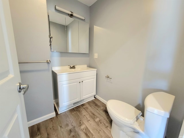 1702 Milburn Blvd, Mishawaka, IN 46544 - bathroom with toilet, vanity, wood finished floors, and baseboards