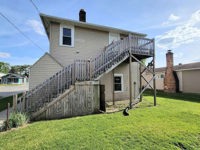 1702 Milburn Blvd, Mishawaka, IN 46544 - back of property featuring stairway, a lawn, a wooden deck, and a chimney