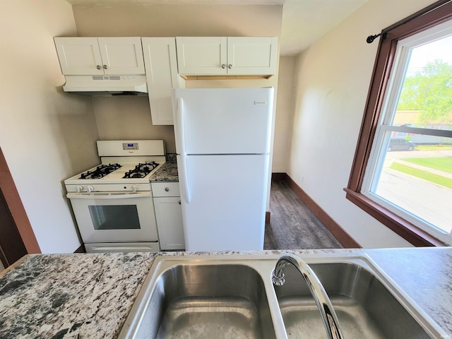 1702 Milburn Blvd, Mishawaka, IN 46544 - kitchen featuring white appliances, under cabinet range hood, healthy amount of natural light, and white cabinets