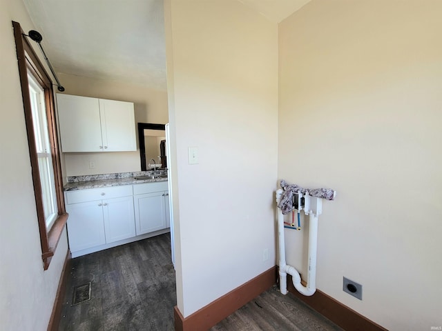 1702 Milburn Blvd, Mishawaka, IN 46544 - washroom with electric dryer hookup, dark wood-style flooring, cabinet space, and healthy amount of natural light