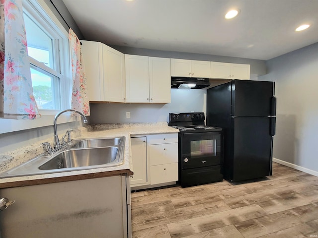 1702 Milburn Blvd, Mishawaka, IN 46544 - kitchen featuring black appliances, under cabinet range hood, a sink, white cabinets, and light wood-style floors