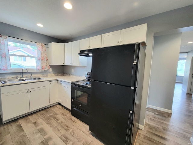 1702 Milburn Blvd, Mishawaka, IN 46544 - kitchen with black appliances, a sink, extractor fan, white cabinetry, and light countertops