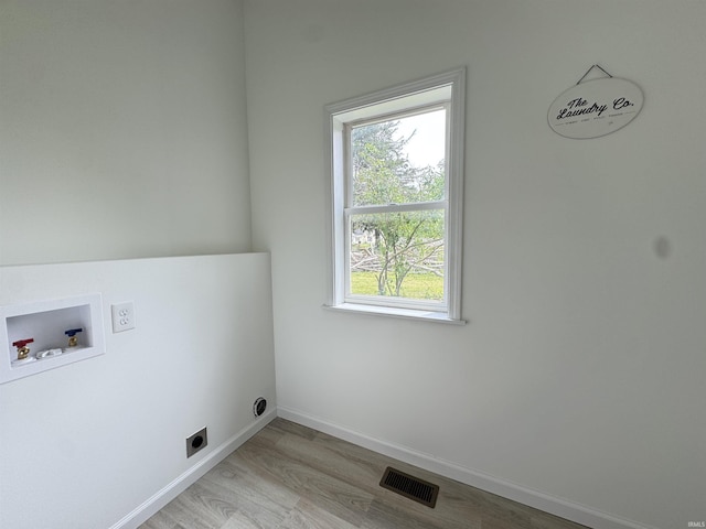 1114 N College St, Veedersburg, IN 47987 - laundry area featuring light wood-style floors, healthy amount of natural light, washer hookup, and baseboards