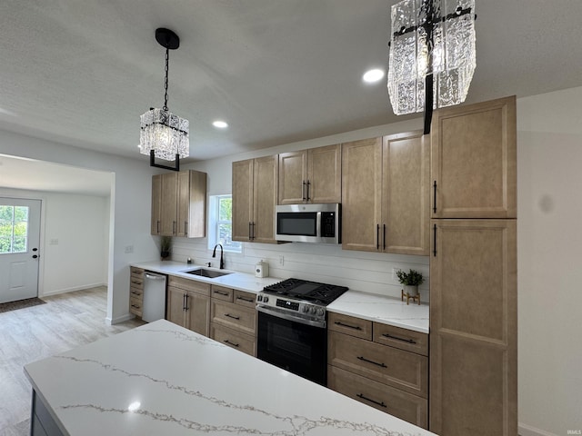 1114 N College St, Veedersburg, IN 47987 - kitchen with appliances with stainless steel finishes, a sink, a chandelier, baseboards, and recessed lighting