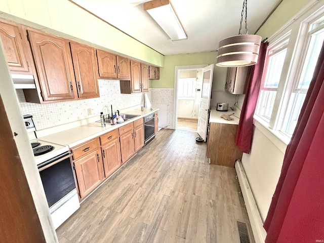 1228 Woodward Ave, New Castle, IN 47362 - kitchen featuring white electric stove, dishwashing machine, a baseboard radiator, light countertops, and light wood finished floors