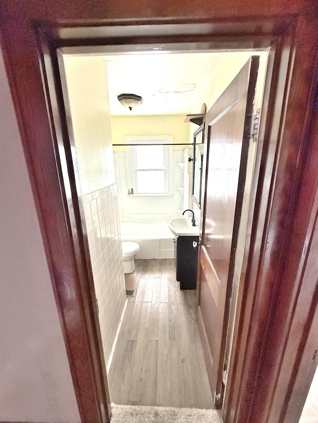 1228 Woodward Ave, New Castle, IN 47362 - full bathroom with wood finished floors, toilet, vanity, and shower / bath combination