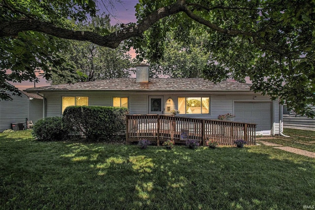 5209 Sunnyfield Pl, South Bend, IN 46619 - back of property with a garage, a lawn, a chimney, and cooling unit