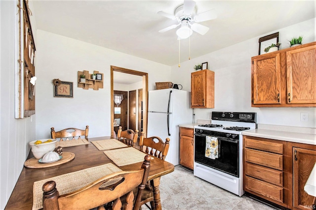 5209 Sunnyfield Pl, South Bend, IN 46619 - kitchen with gas range, freestanding refrigerator, brown cabinetry, a ceiling fan, and light countertops