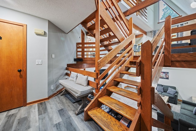 411 N 400 W, West Lafayette, IN 47906 - staircase featuring wood finished floors, baseboards, and a textured ceiling