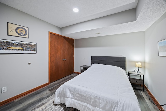 411 N 400 W, West Lafayette, IN 47906 - bedroom with wood finished floors, baseboards, a textured ceiling, and recessed lighting