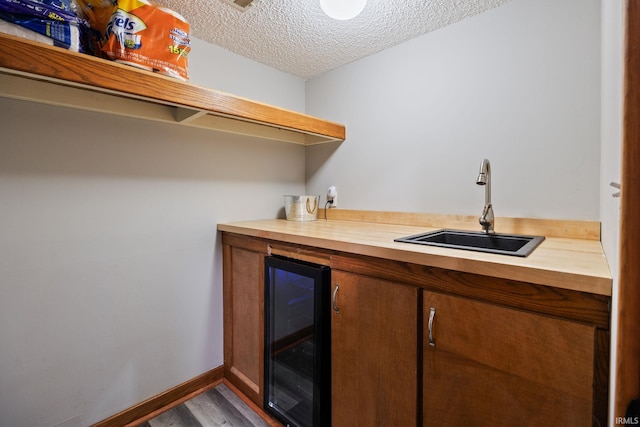 411 N 400 W, West Lafayette, IN 47906 - indoor bar with beverage cooler, a textured ceiling, dark wood-type flooring, and baseboards
