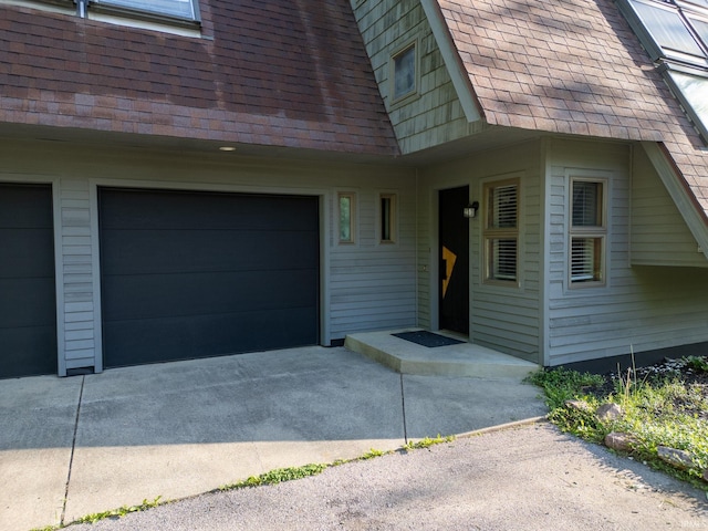 411 N 400 W, West Lafayette, IN 47906 - view of exterior entry featuring a shingled roof, driveway, and a garage